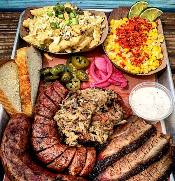 Texas-style bbq platter with brisket, sausage and sides Texas-style bbq platter with brisket, sausage and sides